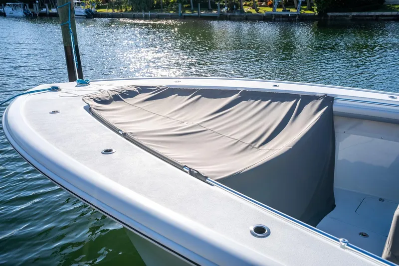 Slide: The Image of 2021 Yellowfin 42 boat with covered bow, docked on a sunny day. - 49