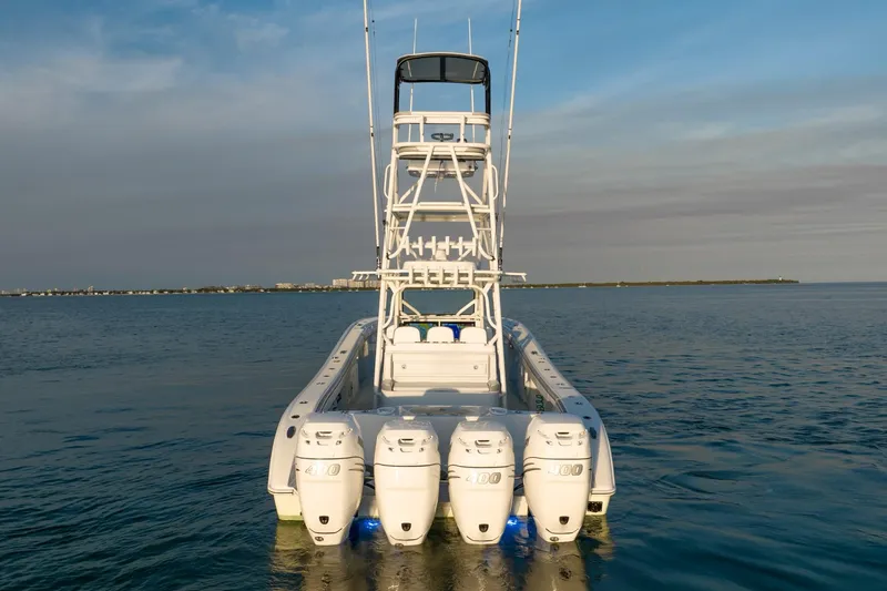 Slide: The Image of 2021 Yellowfin 42 boat with four outboard engines on calm water. - 6