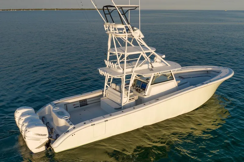 Slide: The Image of 2021 Yellowfin 42 boat with triple outboard engines on calm water. - 7