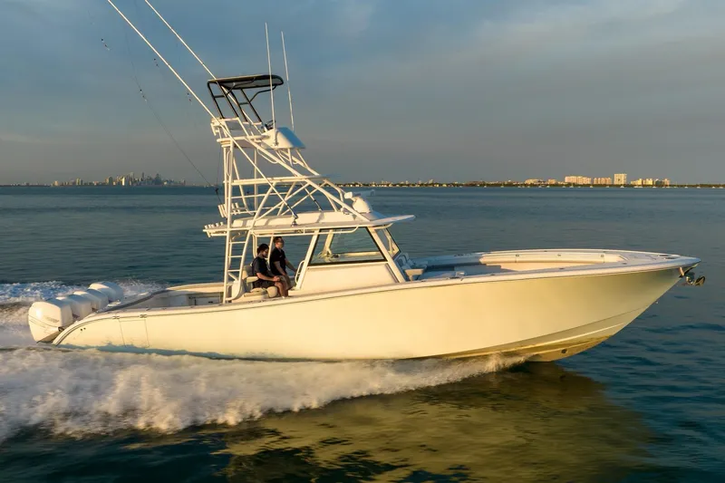 Slide: The Image of 2021 Yellowfin 42 boat cruising on open water at sunset. - 8