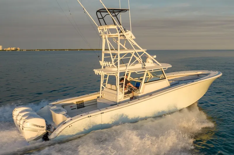 Slide: The Image of 2021 Yellowfin 42 boat cruising on open water at sunset. - 9