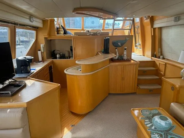 Slide: The Image of Interior of 2000 McKinna 57 Pilothouse yacht with modern kitchen and seating area. - 12