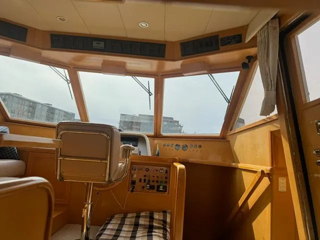Slide: The Image of Interior of 2000 McKinna 57 Pilothouse with helm station and panoramic windows. - 13