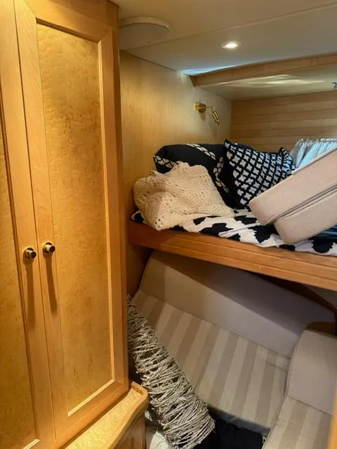 Slide: The Image of Cozy cabin interior of 2000 McKinna 57 Pilothouse with wooden cabinetry and bedding. - 14