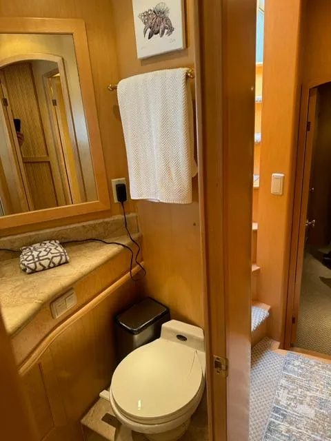 Slide: The Image of Bathroom interior of 2000 McKinna 57 Pilothouse yacht, featuring wooden cabinetry and modern fixtures. - 16