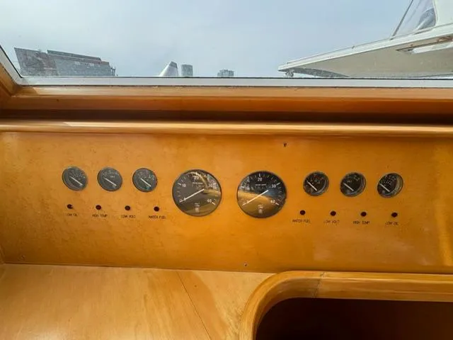 Slide: The Image of Dashboard of a 2000 McKinna 57 Pilothouse yacht with gauges and controls. - 21