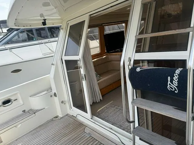 Slide: The Image of 2000 McKinna 57 Pilothouse yacht with open sliding door and interior view. - 22