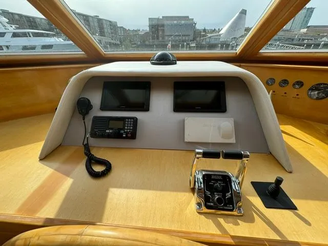 Slide: The Image of Pilothouse of 2000 McKinna 57 yacht with navigation controls and cityscape view. - 24