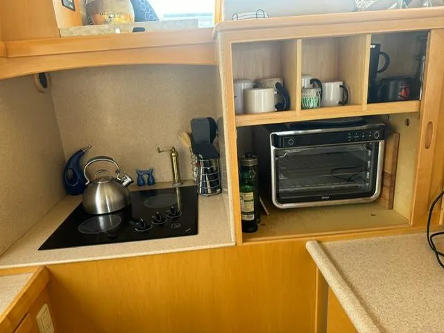 Slide: The Image of Compact kitchen in 2000 McKinna 57 Pilothouse with stove, kettle, and toaster oven. - 25