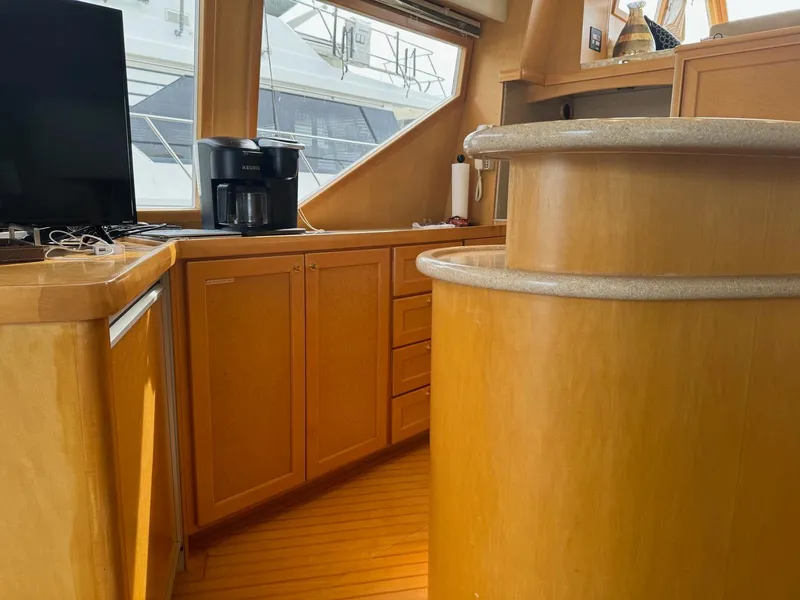 Slide: The Image of Interior of 2000 McKinna 57 Pilothouse yacht with wooden cabinetry and modern appliances. - 28