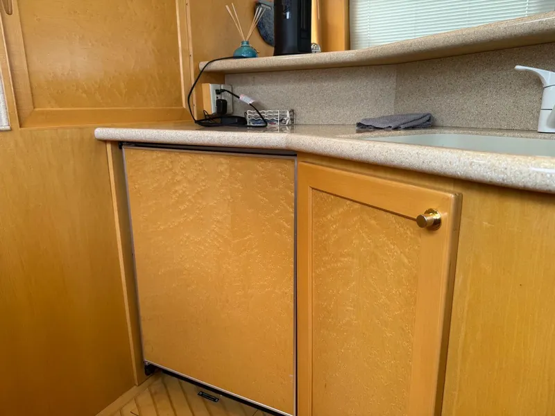 Slide: The Image of Wooden cabinetry in 2000 McKinna 57 Pilothouse yacht kitchen area. - 29