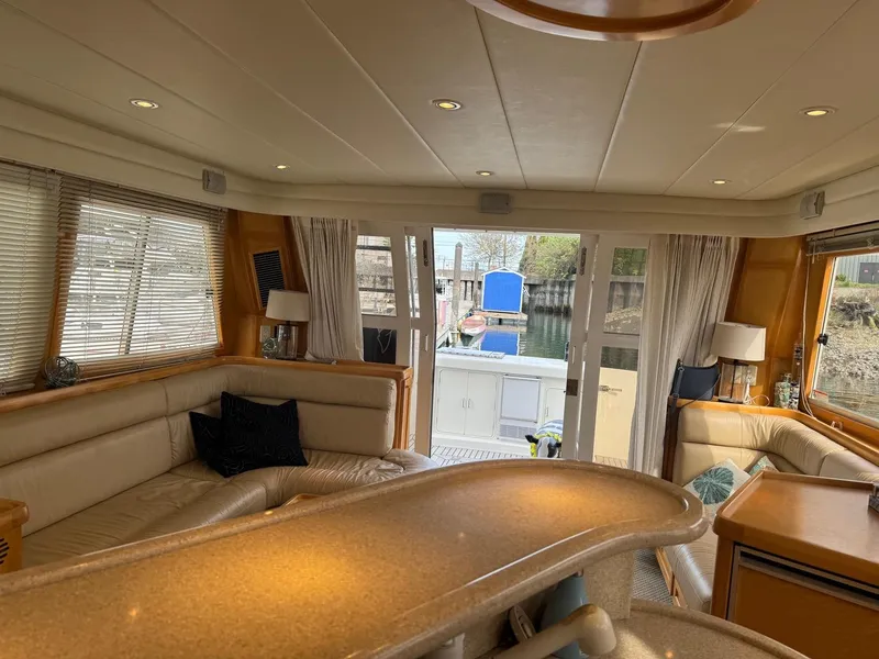 Slide: The Image of Luxurious interior of 2000 McKinna 57 Pilothouse yacht with elegant seating and large windows. - 32