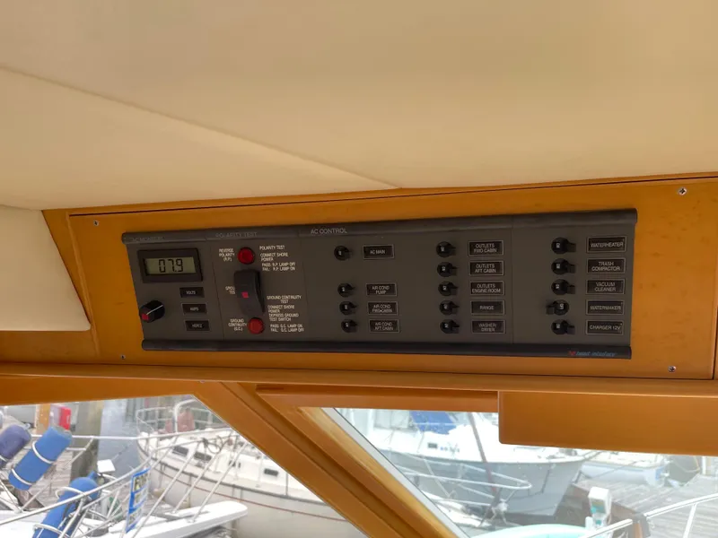 Slide: The Image of Control panel of a 2000 McKinna 57 Pilothouse yacht, featuring various switches and a digital display. - 39