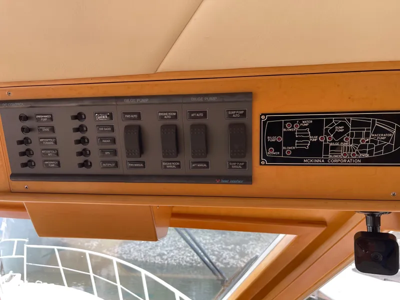 Slide: The Image of Control panel of a 2000 McKinna 57 Pilothouse yacht, featuring switches and a schematic diagram. - 40