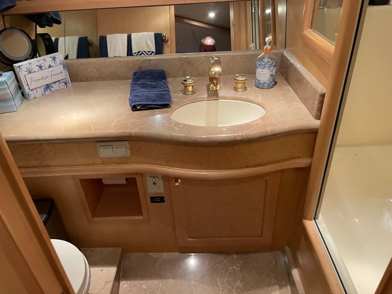 Slide: The Image of Luxurious bathroom in 2000 McKinna 57 Pilothouse yacht with marble countertop and gold fixtures. - 44