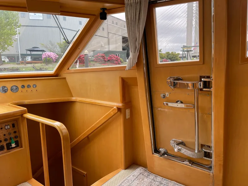 Slide: The Image of Interior of 2000 McKinna 57 Pilothouse yacht with wooden finishes and large windows. - 45
