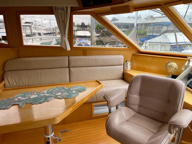 Slide: The Image of Interior of 2000 McKinna 57 Pilothouse yacht with leather seating and wooden accents. - 46