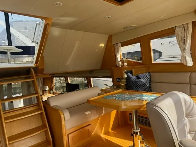 Slide: The Image of Luxurious interior of 2000 McKinna 57 Pilothouse yacht with elegant seating and table. - 7