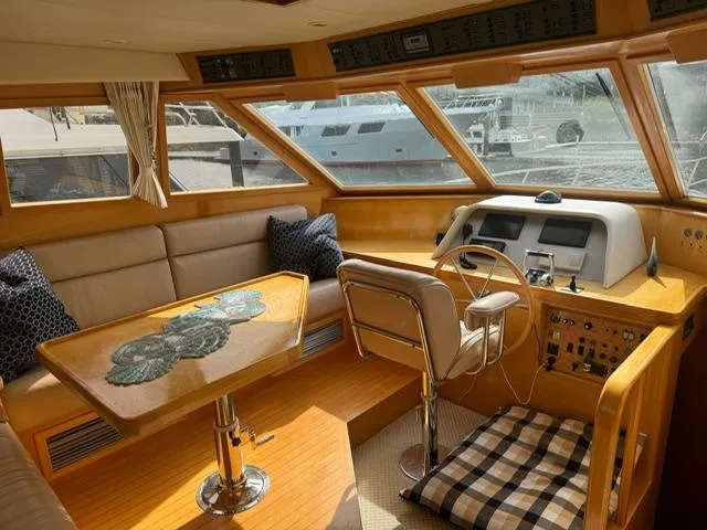 Slide: The Image of Luxurious 2000 McKinna 57 Pilothouse interior with helm, seating, and table. - 8