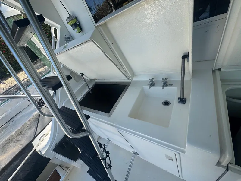 Slide: The Image of 1989 Bertram 50 Convertible yacht kitchen area with sink and storage compartments. - 13