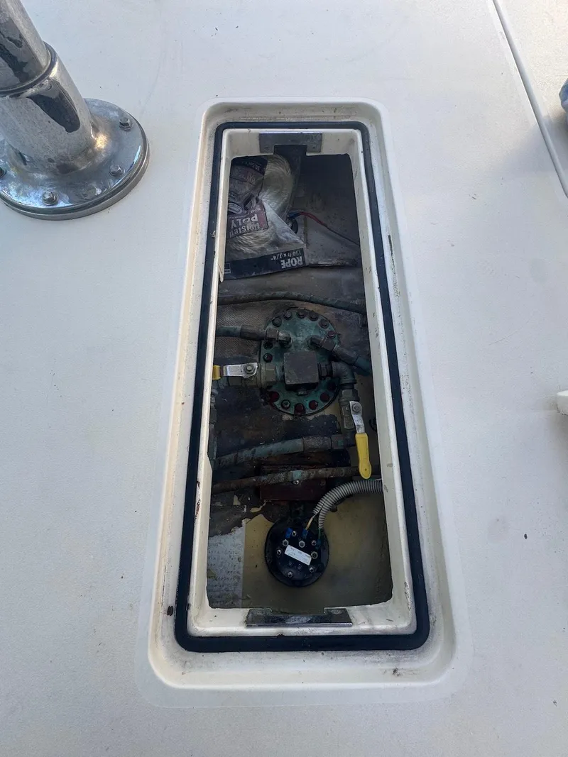 Slide: The Image of 1989 Bertram 50 Convertible engine compartment with visible components and wiring. - 14