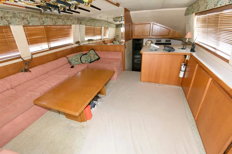 Slide: The Image of Interior of 1989 Bertram 50 Convertible yacht with pink sofa and wooden furnishings. - 15