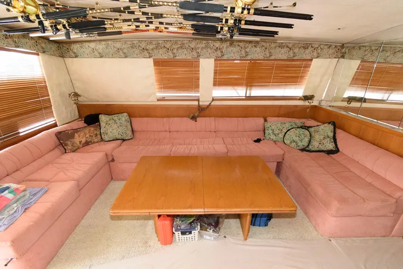 Slide: The Image of Interior of 1989 Bertram 50 Convertible yacht with pink seating and wooden table. - 16