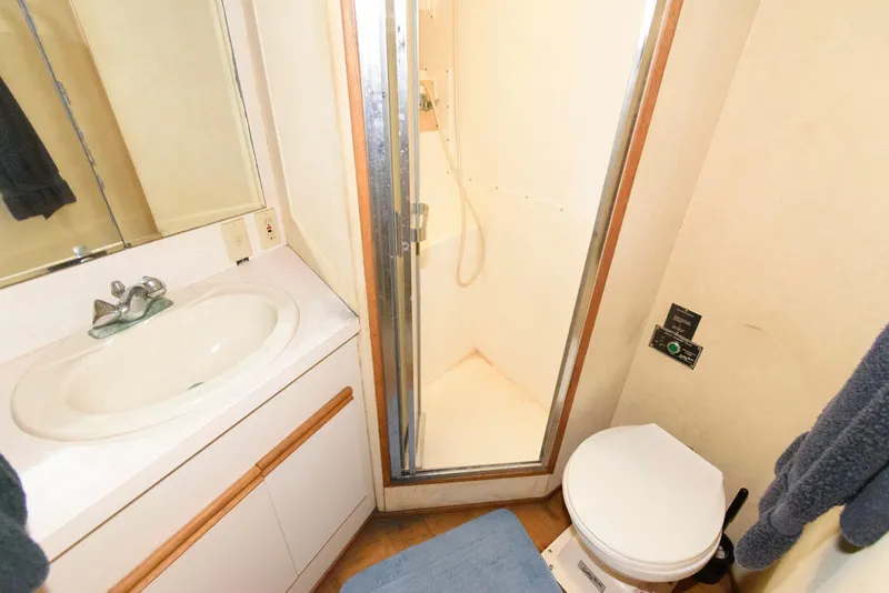 Slide: The Image of Bathroom interior of 1989 Bertram 50 Convertible yacht with shower, sink, and toilet. - 22