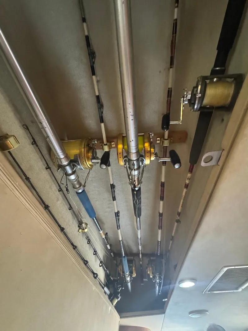 Slide: The Image of Fishing rods stored on a 1989 Bertram 50 Convertible boat ceiling. - 24