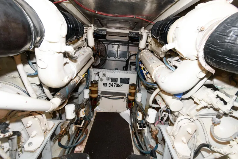 Slide: The Image of Engine room of a 1989 Bertram 50 Convertible yacht, showcasing dual engines. - 26