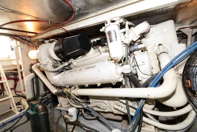 Slide: The Image of Engine room of a 1989 Bertram 50 Convertible yacht, showcasing a powerful marine engine. - 27