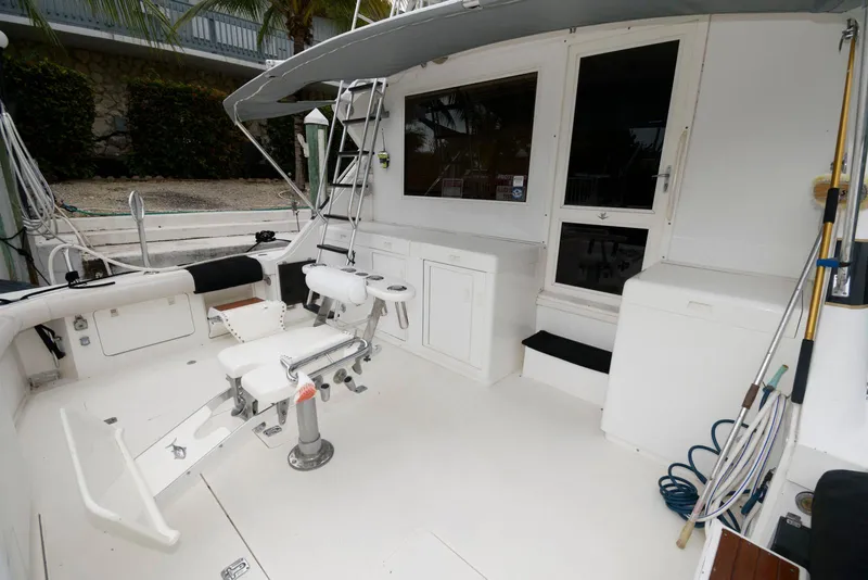 Slide: The Image of 1989 Bertram 50 Convertible yacht deck with fishing chair and equipment. - 3