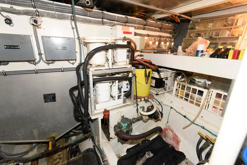 Slide: The Image of Engine room of 1989 Bertram 50 Convertible with equipment and storage. - 30