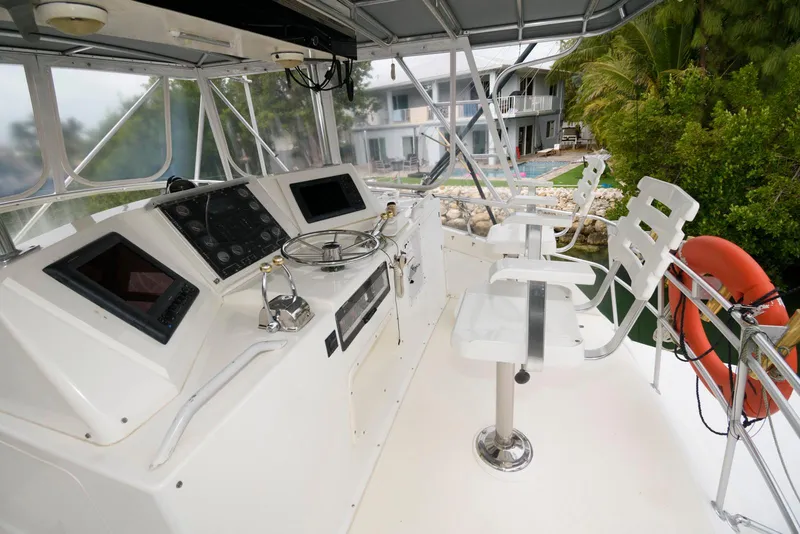 Slide: The Image of 1989 Bertram 50 Convertible yacht helm with modern controls and seating. - 6