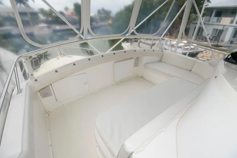 Slide: The Image of 1989 Bertram 50 Convertible yacht with spacious white seating area and clear canopy. - 7