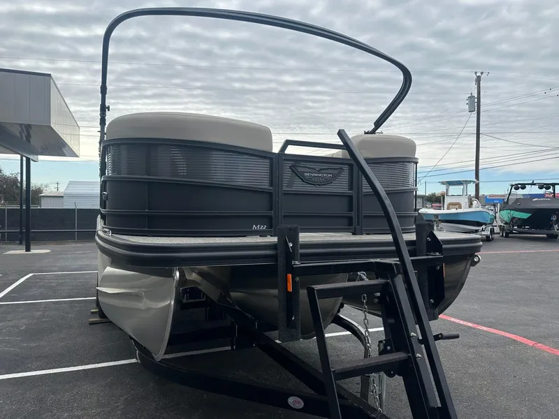 Slide: The Image of 2025 Bennington 22MFB pontoon boat on trailer in parking lot. - 10