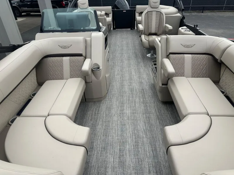 Slide: The Image of 2025 Bennington 22MFB boat interior with luxurious beige seating and modern design. - 11