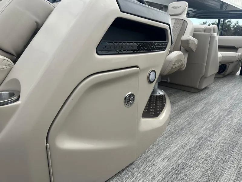 Slide: The Image of 2025 Bennington 22MFB boat interior with beige seating and modern design. - 18