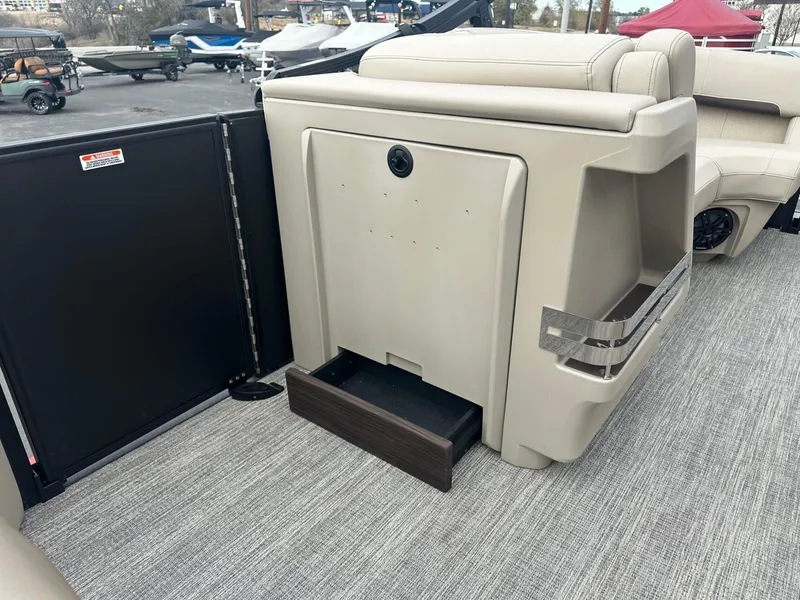 Slide: The Image of 2025 Bennington 22MFB boat interior with beige seating and storage compartment. - 19