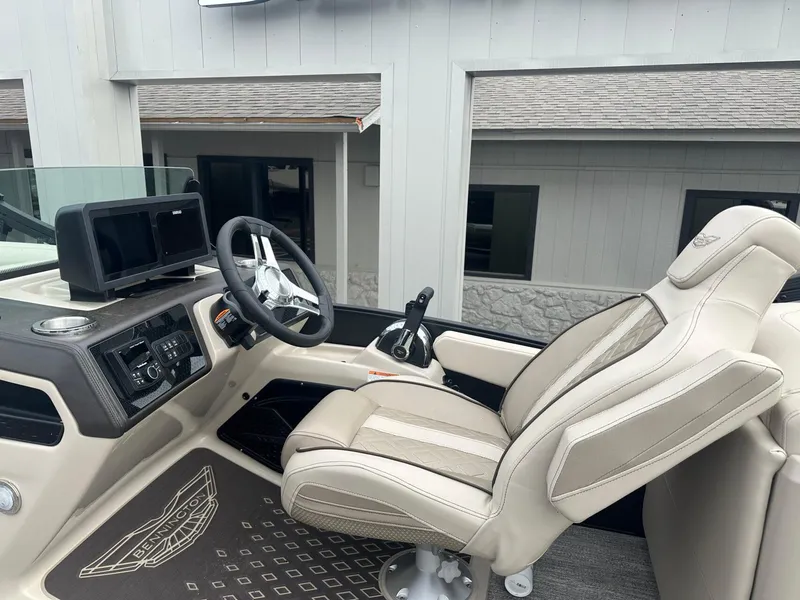 Slide: The Image of 2025 Bennington 22MFB boat interior with steering wheel and captain's chair. - 20