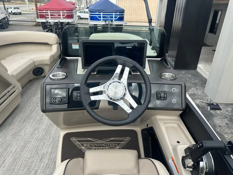 Slide: The Image of 2025 Bennington 22MFB boat dashboard with steering wheel and control panel. - 22