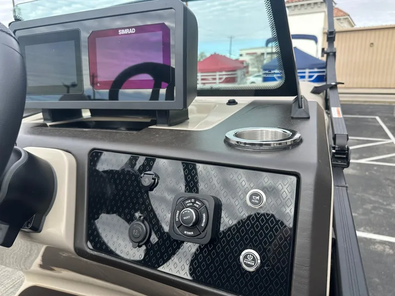 Slide: The Image of Dashboard of 2025 Bennington 22MFB boat with Simrad display and control panel. - 24