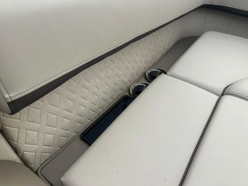 Slide: The Image of 2025 Bennington 22MFB boat interior with cushioned seating and cup holders. - 29