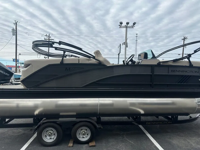 Slide: The Image of 2025 Bennington 22MFB pontoon boat on trailer under cloudy sky. - 8