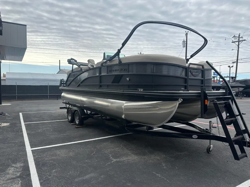 Slide: The Image of 2025 Bennington 22MFB pontoon boat on trailer in parking lot. - 9