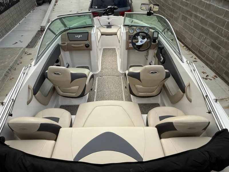 Slide: The Image of 2014 Chaparral 18 Ski & Fish H2O boat interior with beige seating and dashboard. - 11