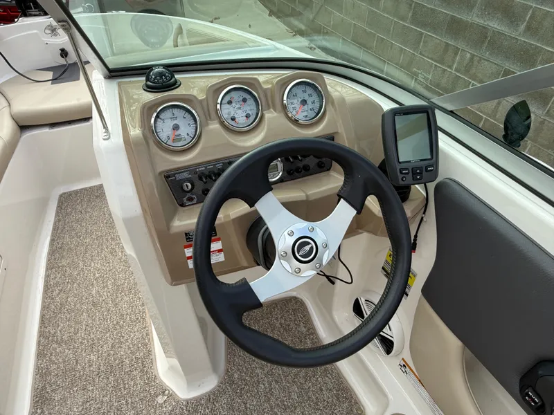 Slide: The Image of 2014 Chaparral 18 Ski & Fish H2O boat dashboard with steering wheel and gauges. - 6