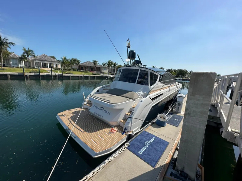 Slide: The Image of 2021 Azimut Atlantis 45 yacht docked in a serene marina setting. - 10