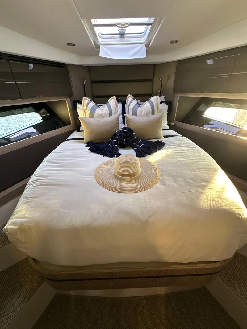 Slide: The Image of Luxurious bedroom interior of 2021 Azimut Atlantis 45 yacht with elegant bedding and natural light. - 15