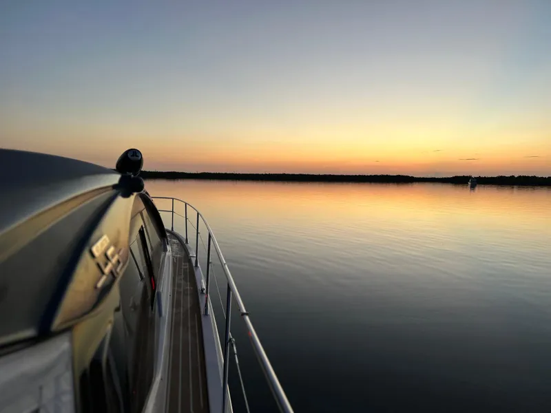 Slide: The Image of Azimut Atlantis 45 yacht cruising at sunset, 2021 model, serene water view. - 31